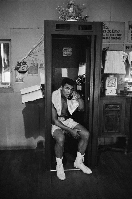 Muhammad Ali takes a break from training to talk on the phone